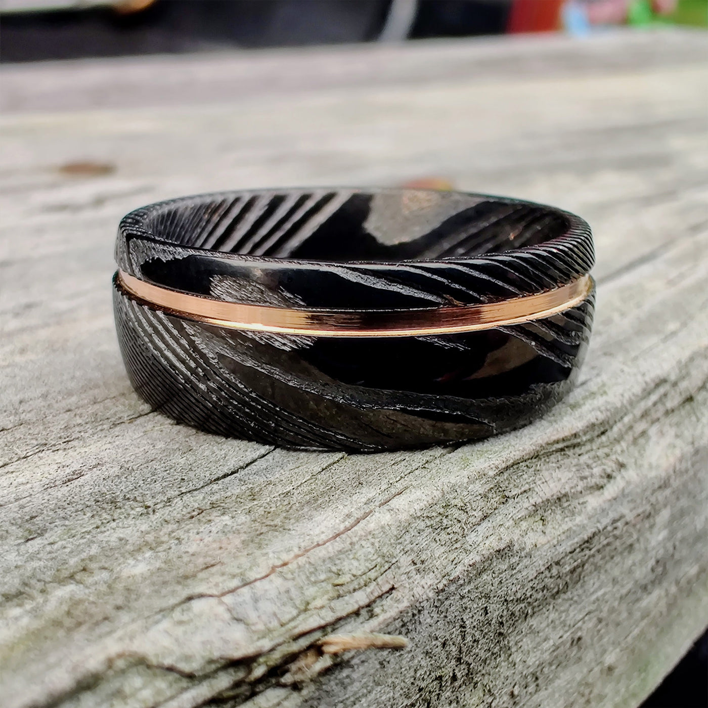 The Direwolf Thorum Damascus Steel and Rose Gold Inlay Ring